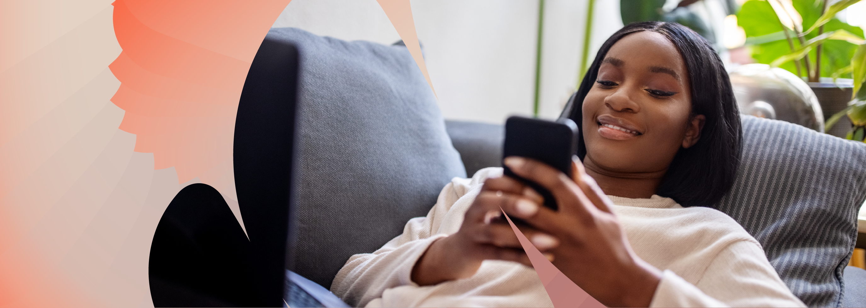 Person relaxing on a sofa and looking at a smartphone, with plants and natural light in the background.