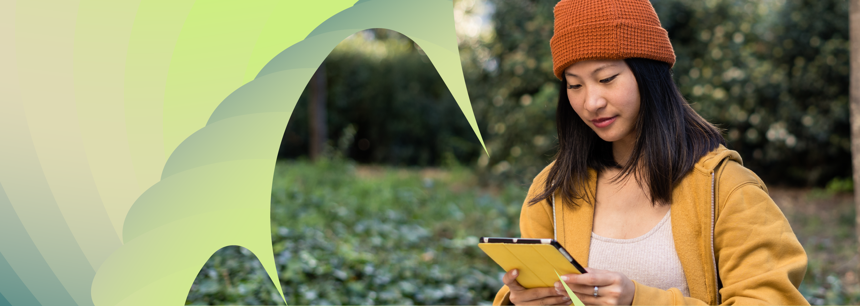 Woman in a park using a tablet outdoors.
