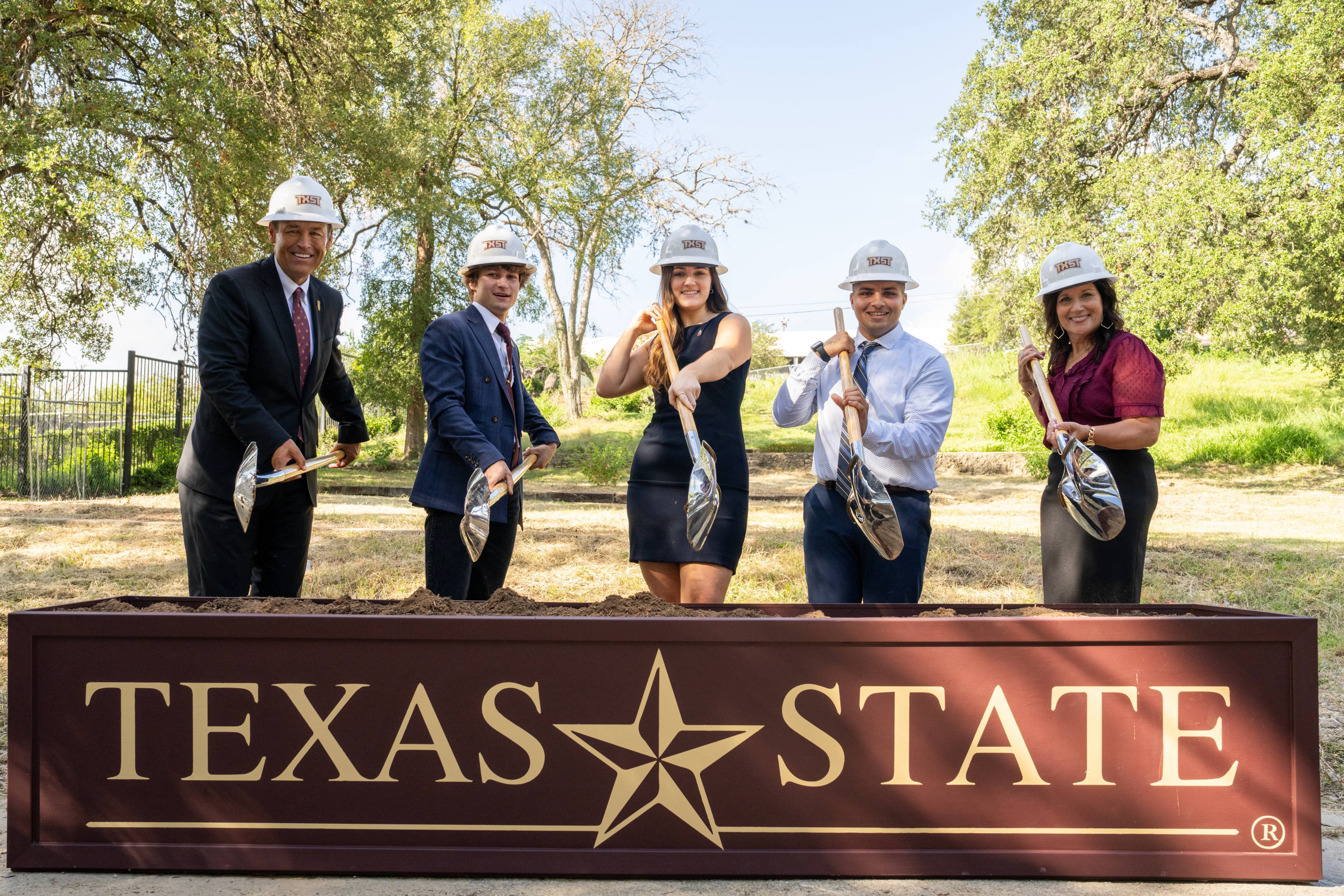 A group of people posing for a ground breaking ceremony photo