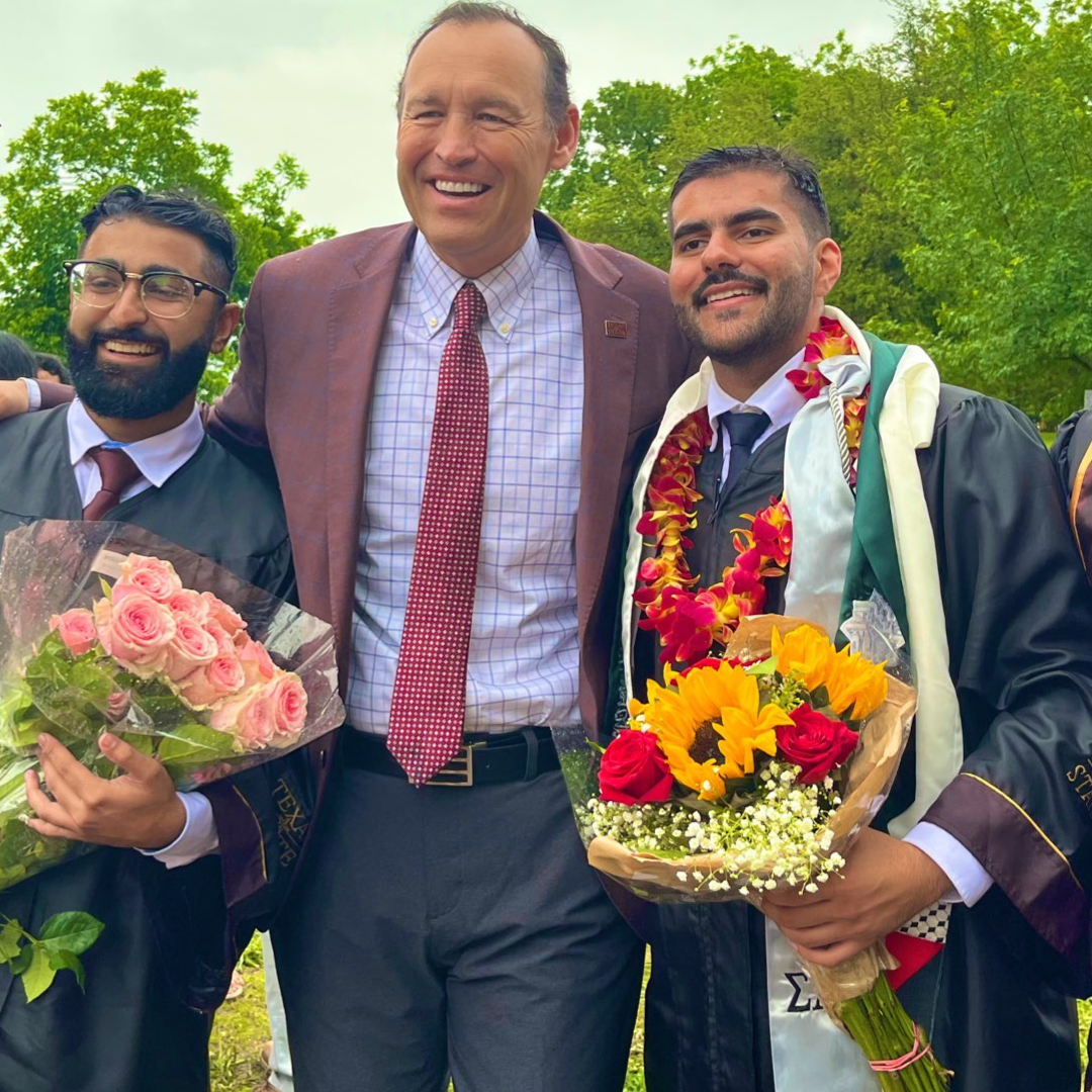 President Kelly Damphousse with two students after commencement