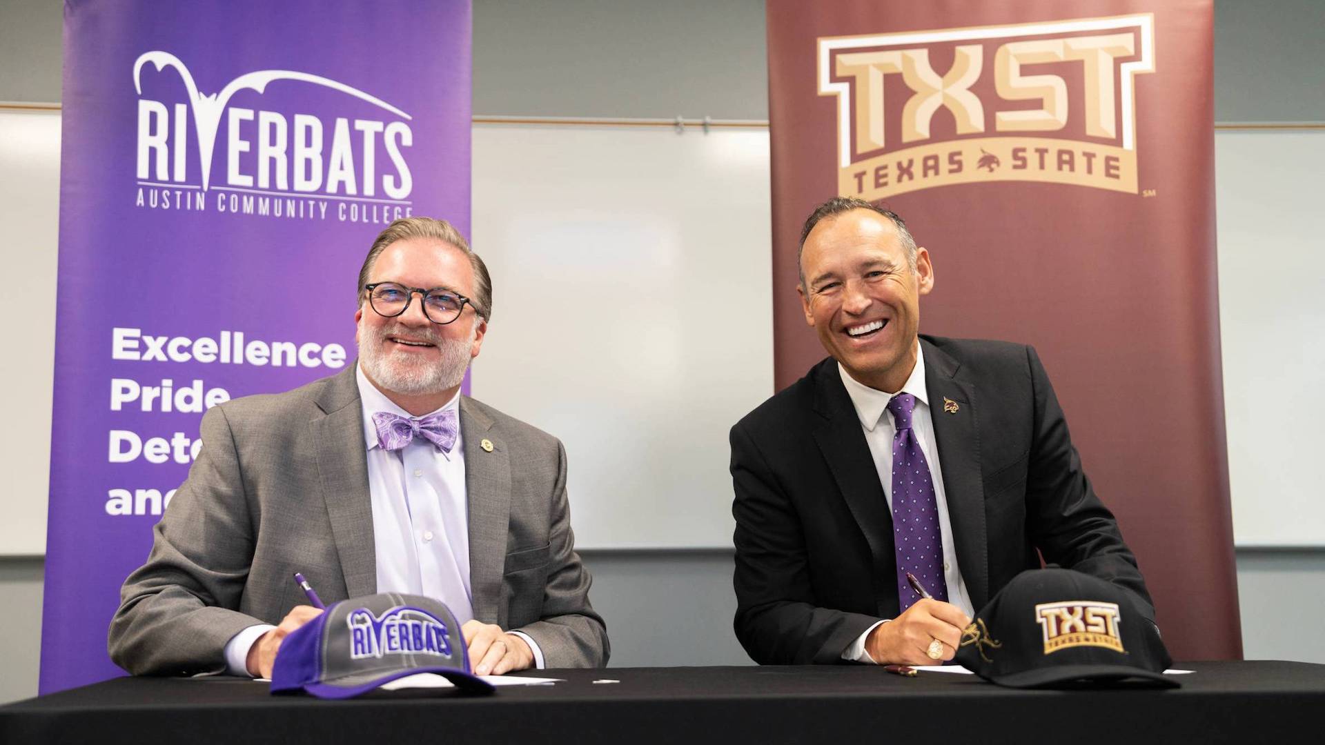 ACC Chancellor Russell Lowery-Hart and TXST President Kelly Damphousse pose for photo at signing for Bats to Cats partnership