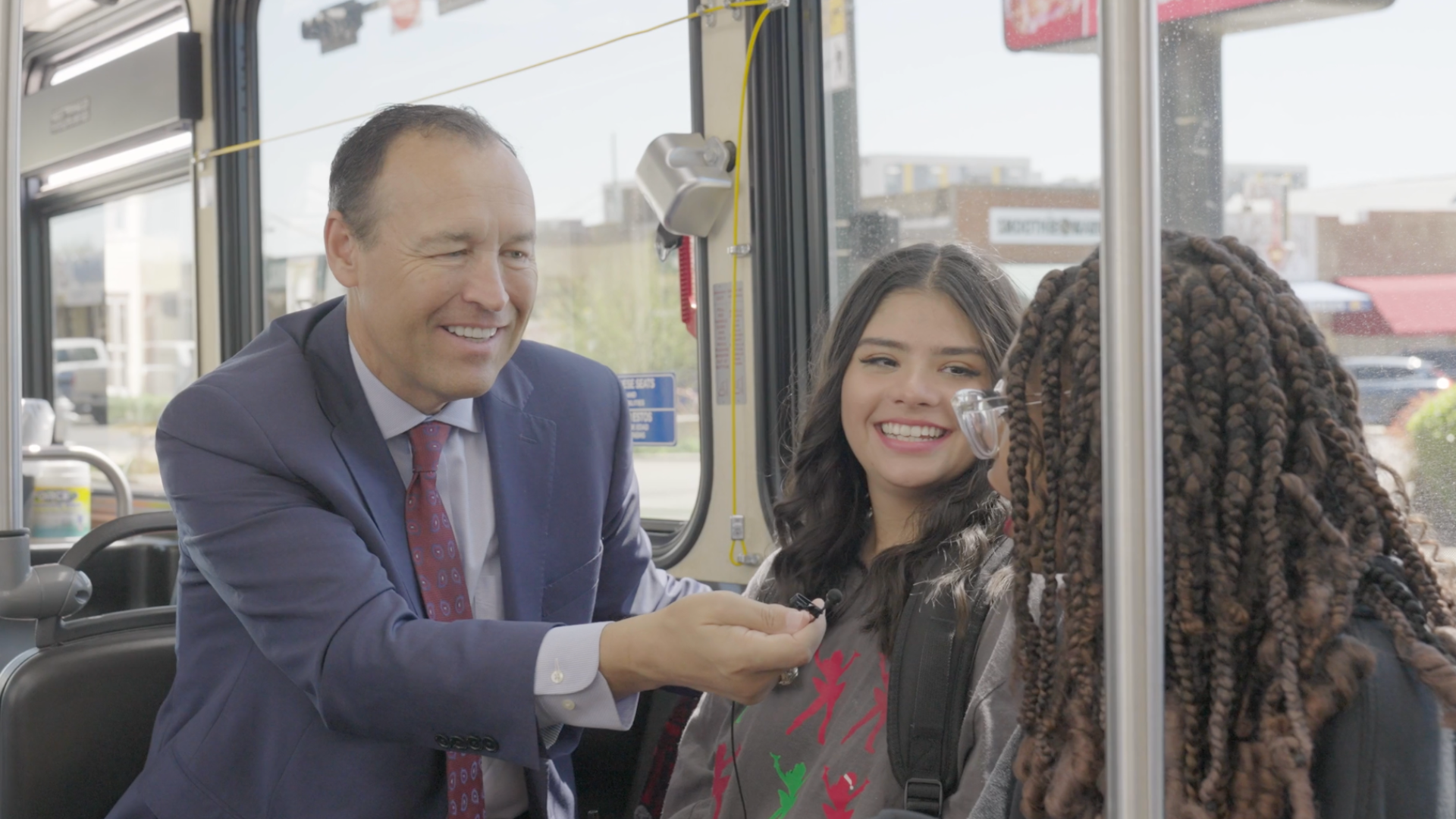 President Damphousse chats with TXST students on the bus