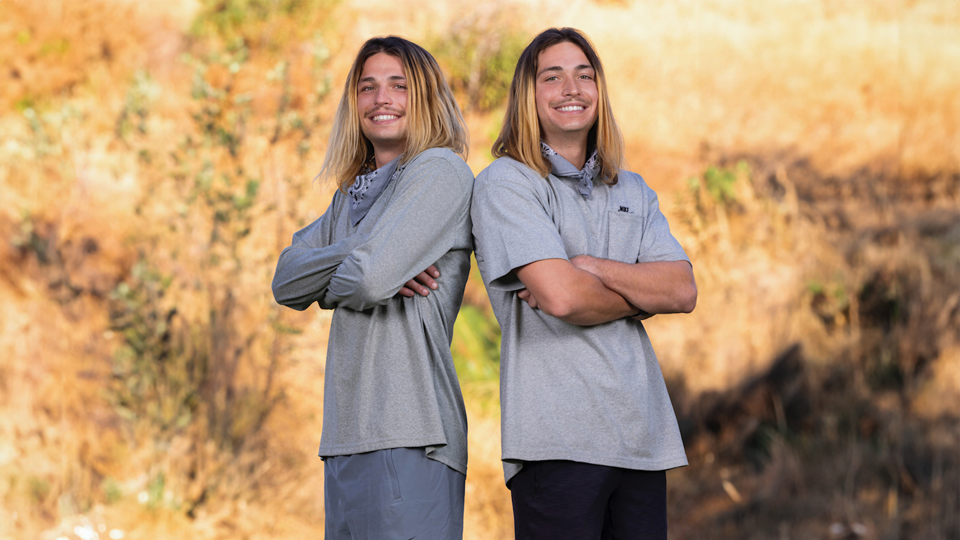 twin brothers standing in a field