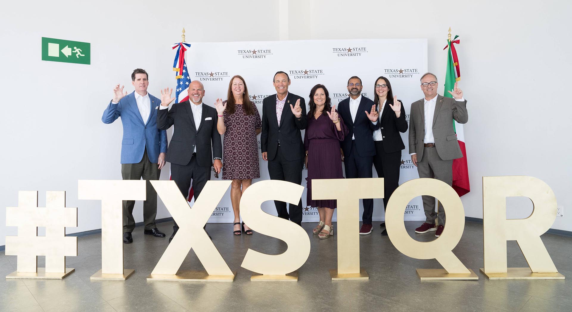 TXST President Kelly Damphousse poses with various leadership from TXST and Elisia Education Hub.