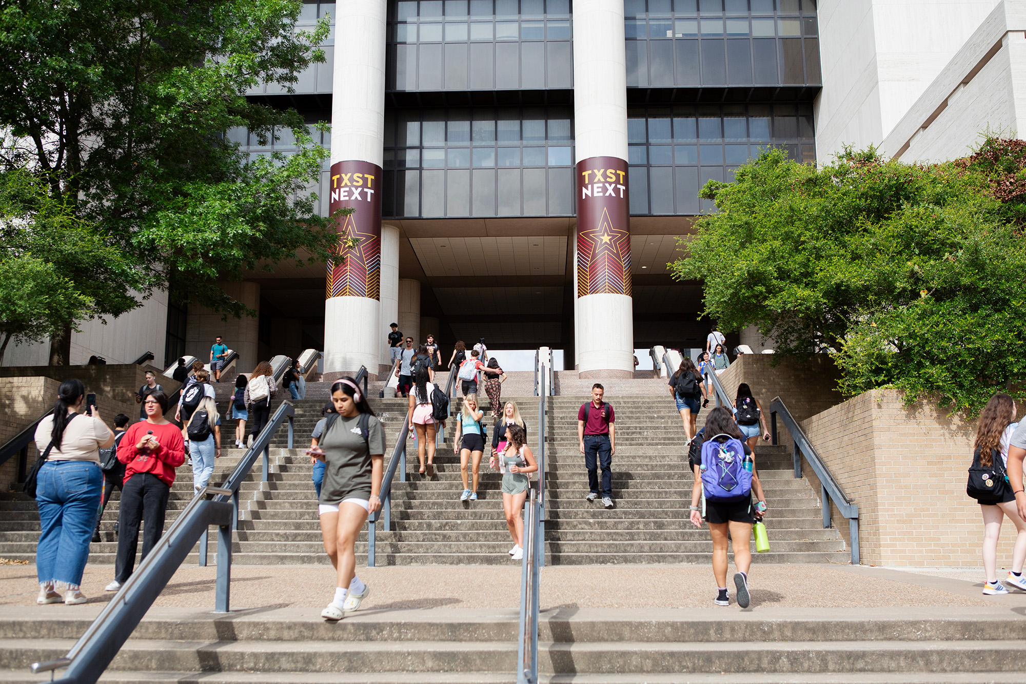 students walking up stairs on campus