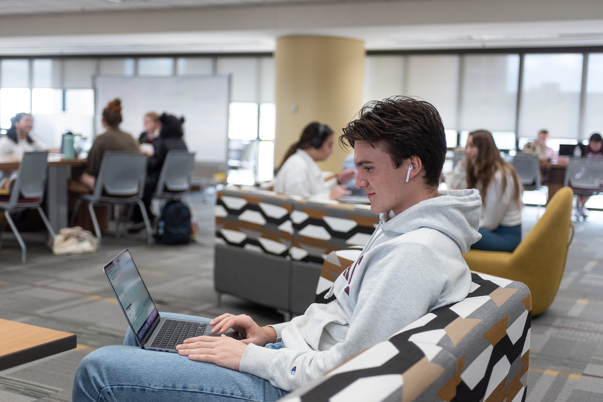 a student typing on a laptop