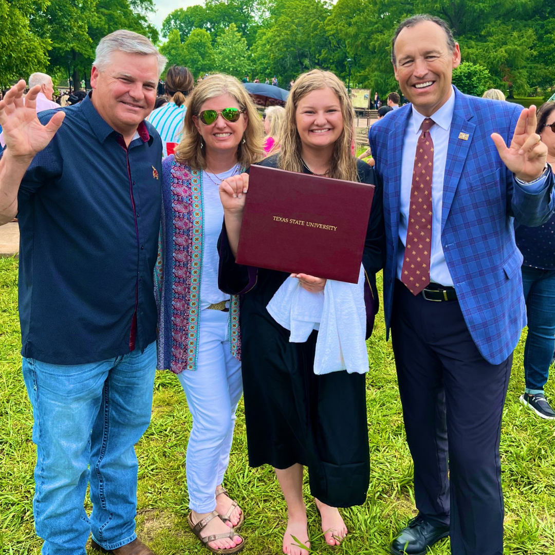 President Kelly Damphousse with student and their family after commencement