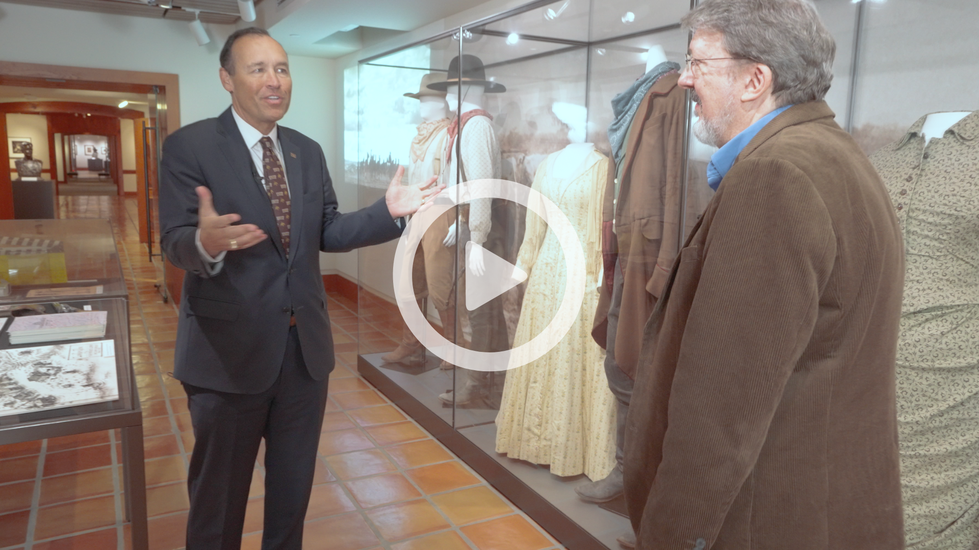 President Damphousse with Dr. Coleman inside The Wittliff Collections with play button