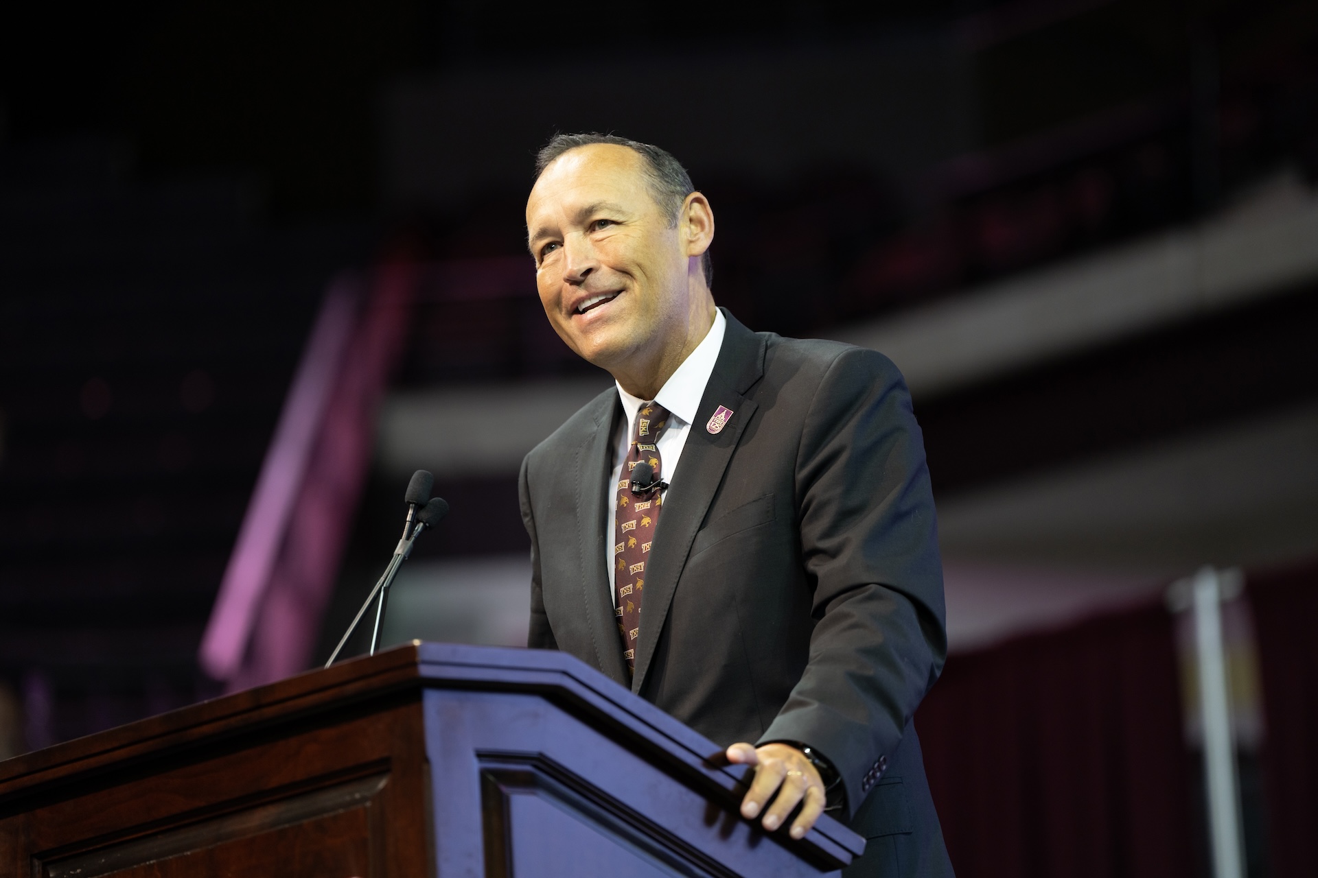 Texas State University President, Dr. Kelly Damphousse standing at a podium