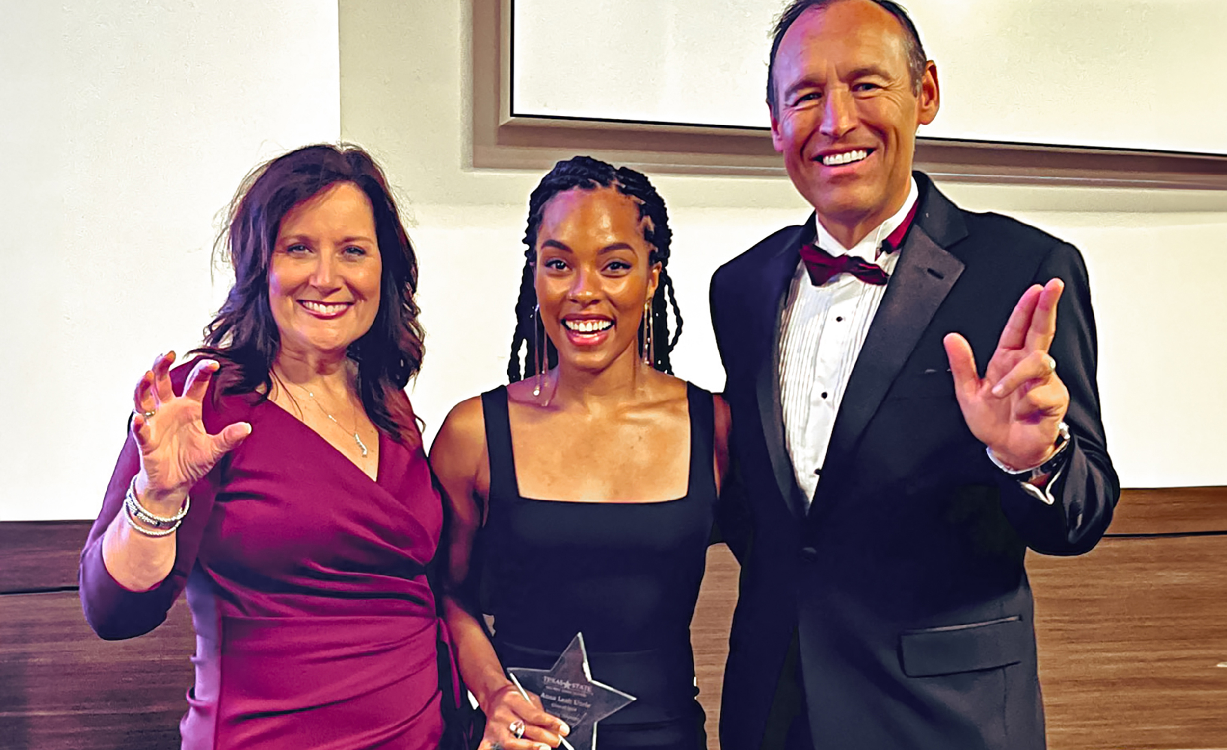 president and first lady damphousse with a distinguished alum recipient