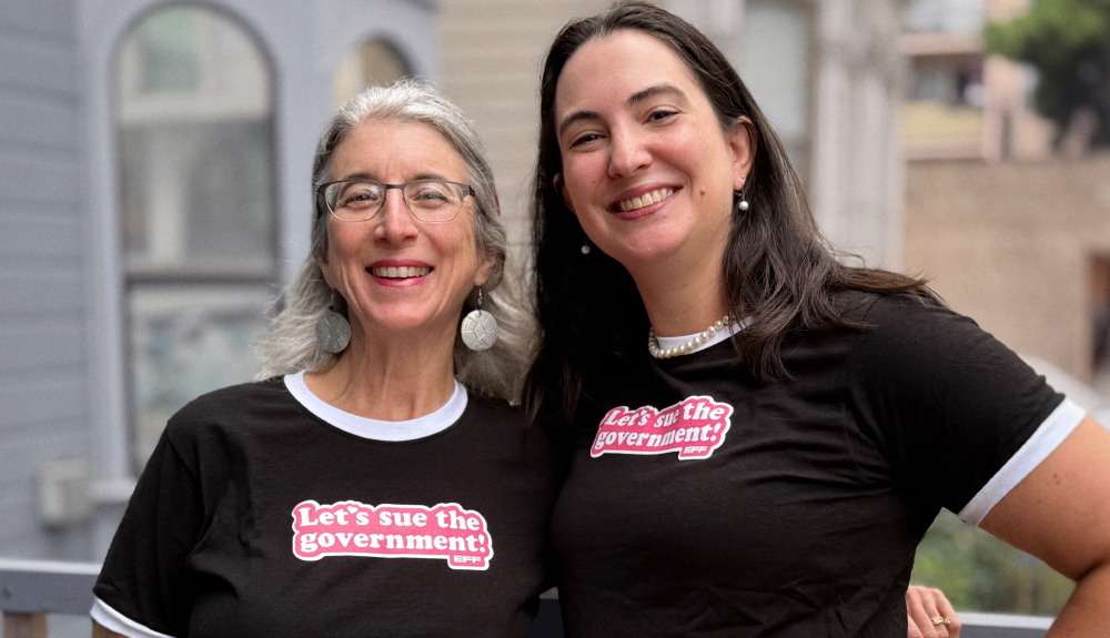Two people wearing EFF's Let's Sue the Government T-Shirt