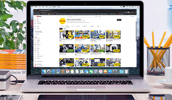 Image of a laptop with a screenshot of the FANUC YouTube Channel webpage