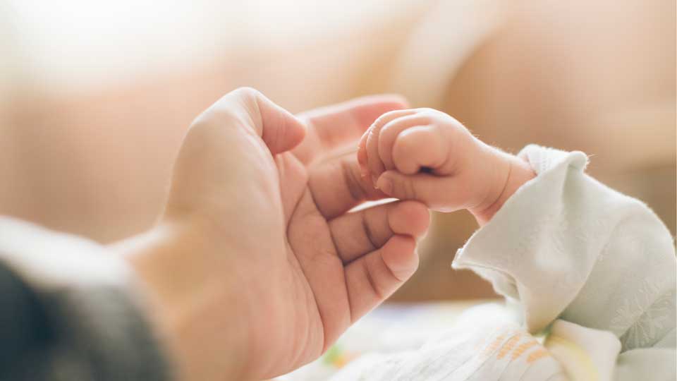 Holding a baby's hand