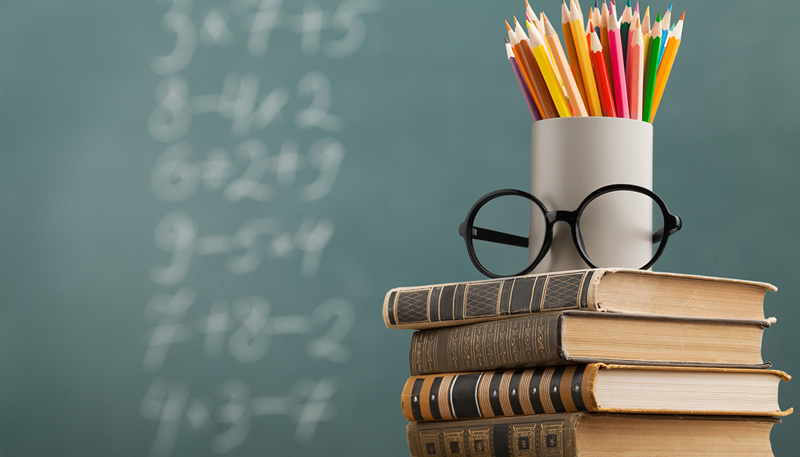 school books and chalk board