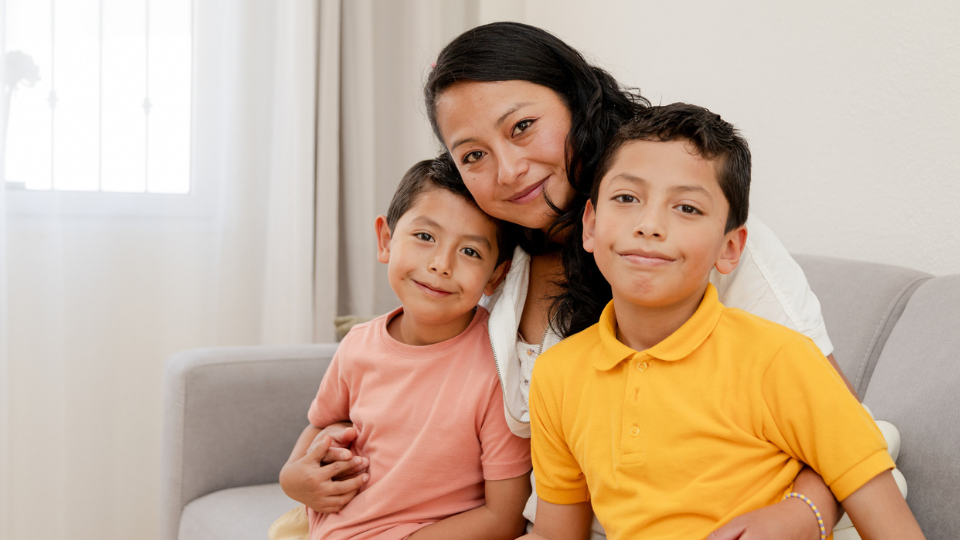 Mother with 2 sons posing for a picture