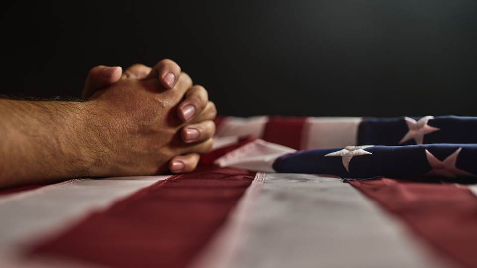 Praying hands with Flag
