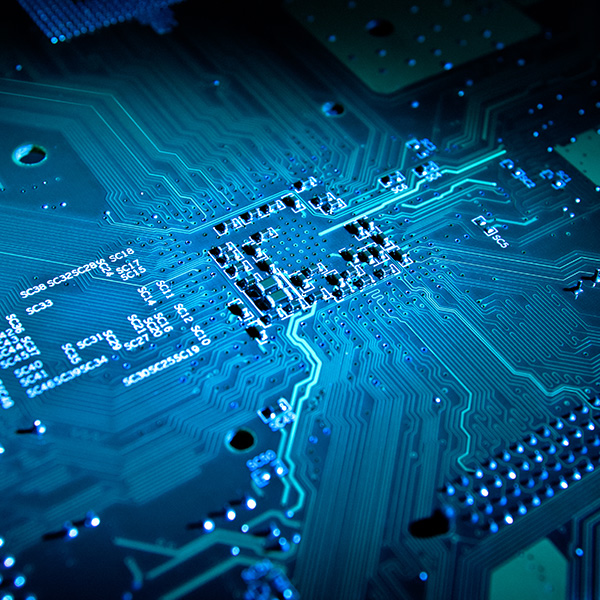 A close view of a circuit board shows detailed patterns and blue lights. The circuitry connects various components and creates pathways for electrical signals.