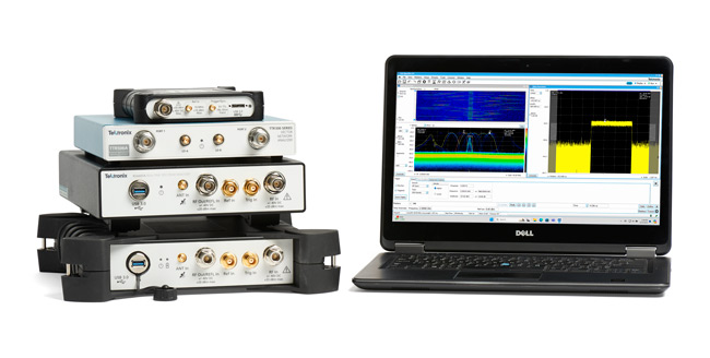 Compact, portable Tektronix RSA spectrum analyzers next to a PC running SignalVu software for spectrum analysis.